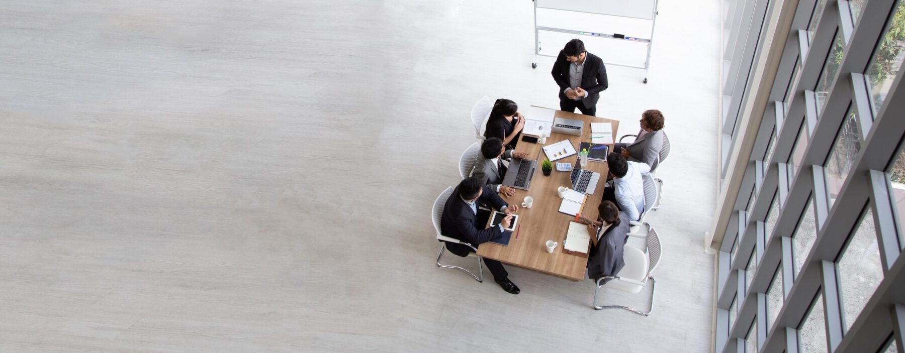 Aerial view with businessman and businesswoman sitting around a conference table