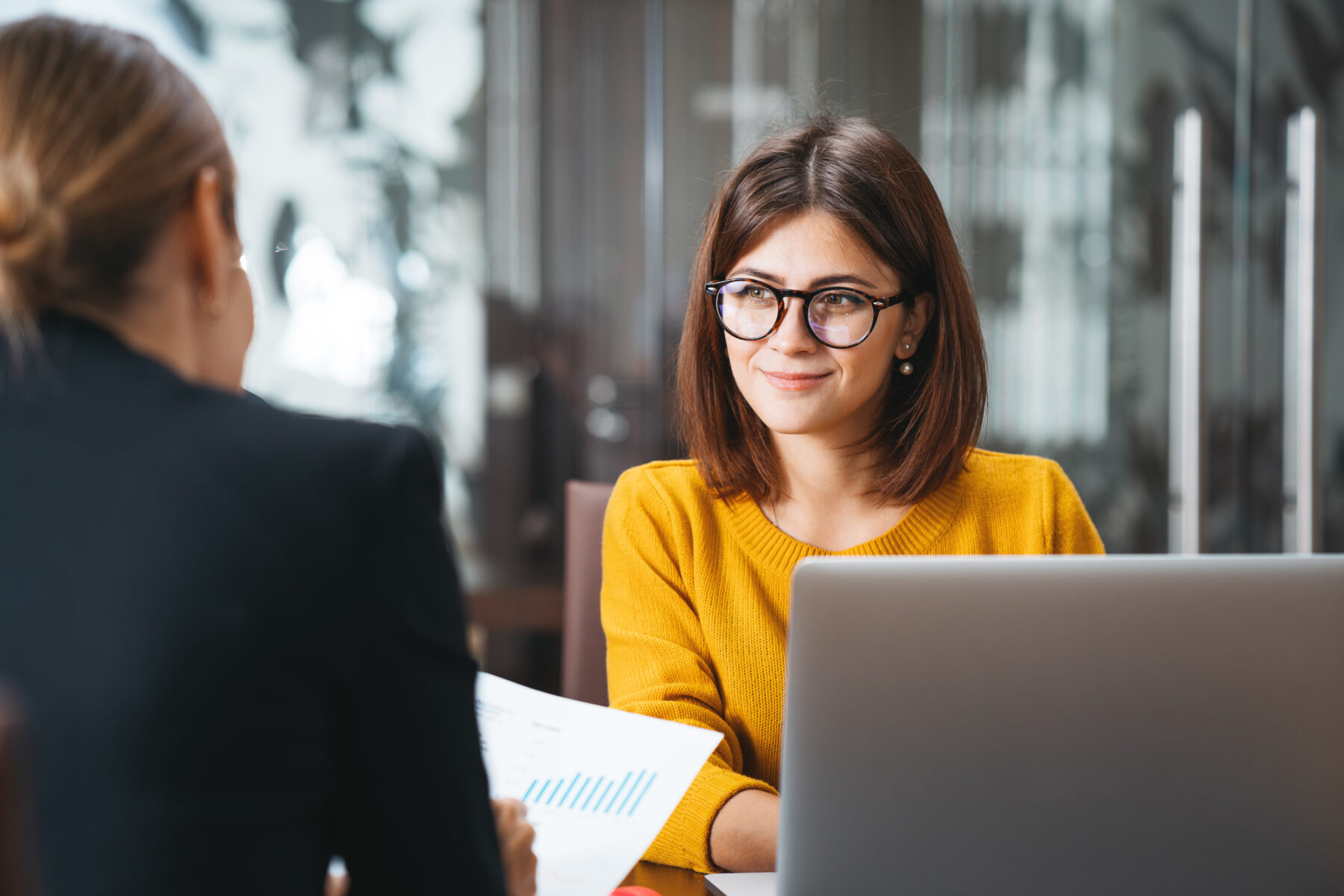 Professional financial planner listens to client during review of financial data