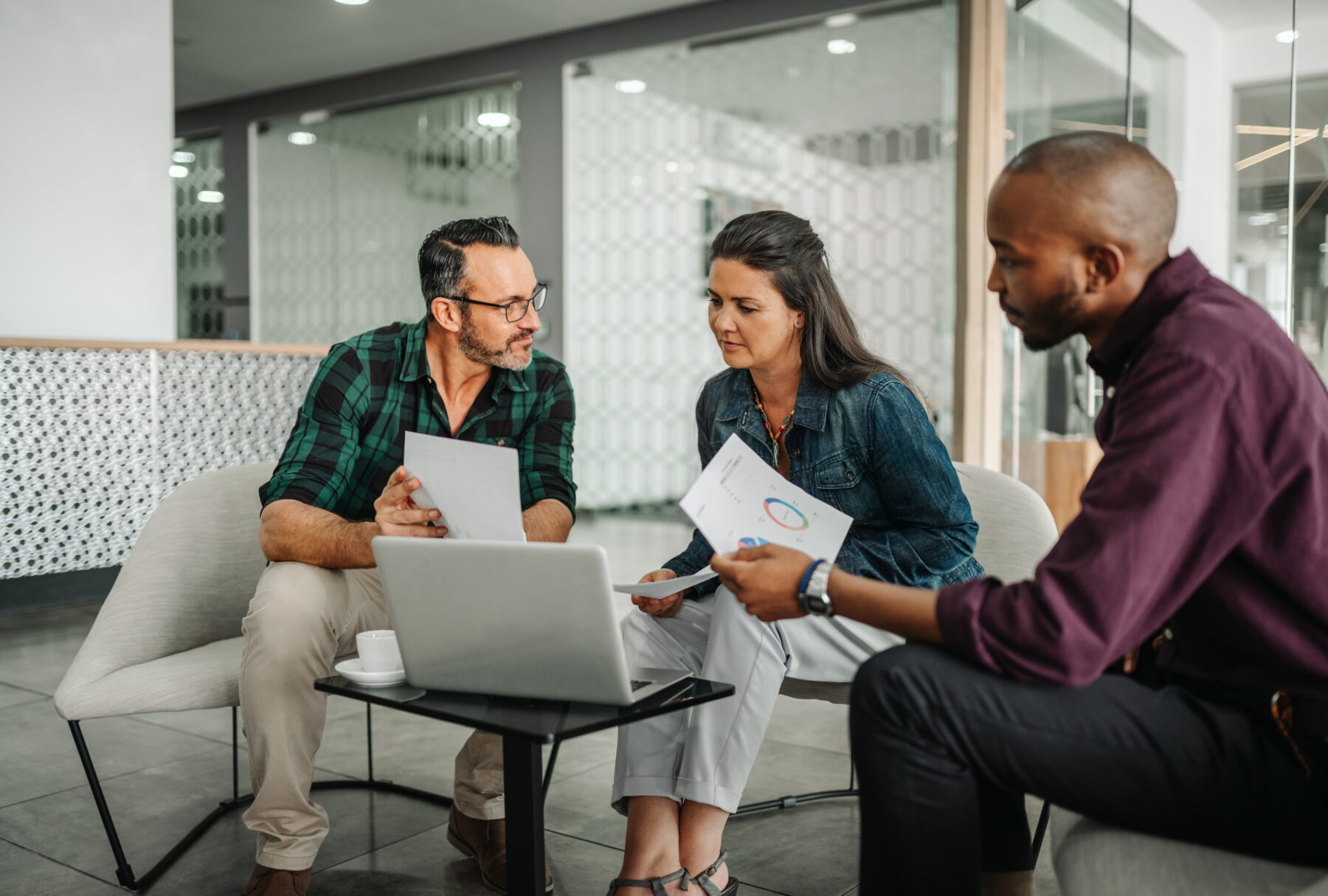 Mature couple meets with financial planner to discuss retirement plans and review data