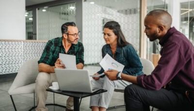 Mature couple meets with financial planner to discuss retirement plans and review data